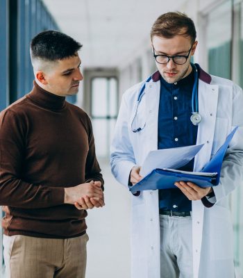 Doctor talking with his patient at clinic Doctor talking with his patient at clinic
